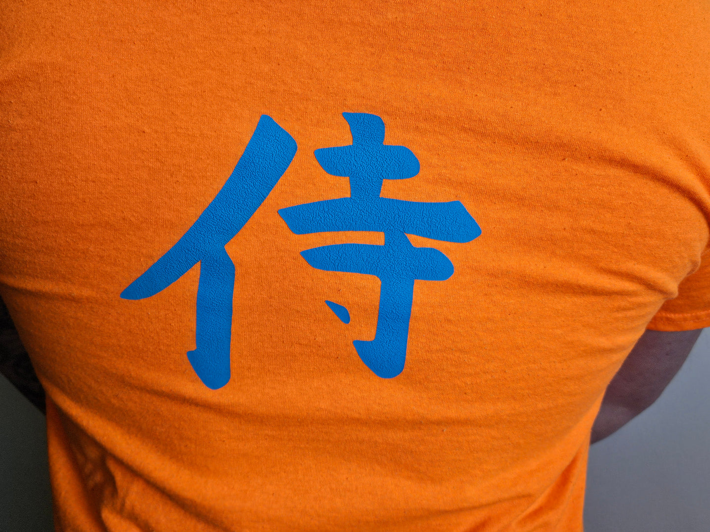 3D Puff Glow in The Dark. Samurai Print on Safety Orange T-Shirt. High quality cotton Tees with a Samurai Graphic at the front and the Samurai writing at the back and sleeve