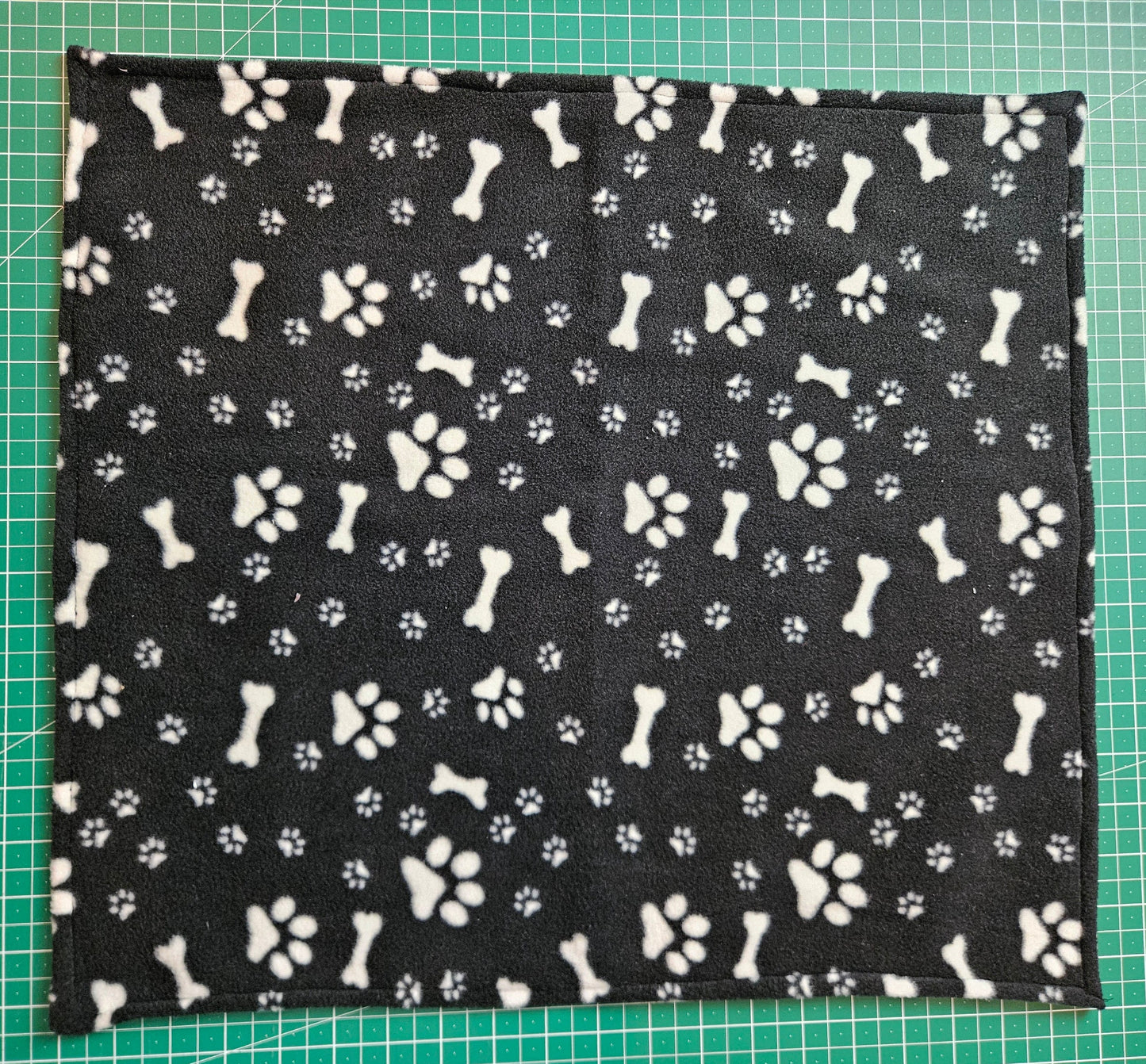 Little Pet Blanket. Dog theme Anti Pill Polar Fleece Fabric with paw and bones prints. Selection of pink or black background