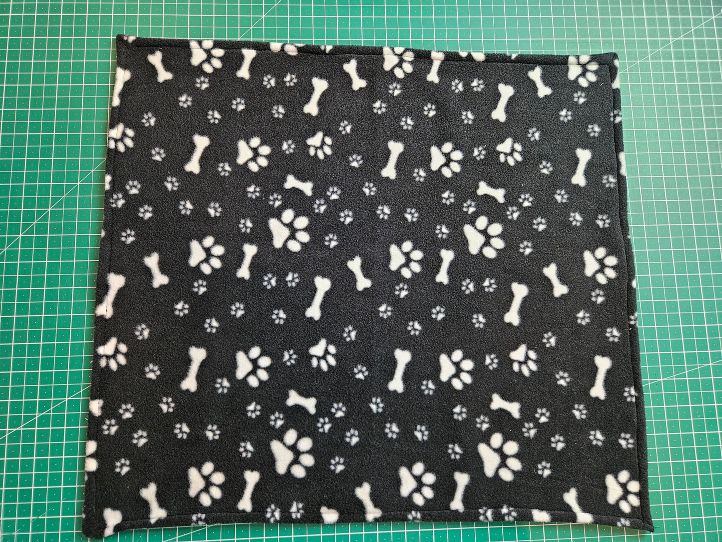 Little Pet Blanket. Dog theme Anti Pill Polar Fleece Fabric with paw and bones prints. Selection of pink or black background