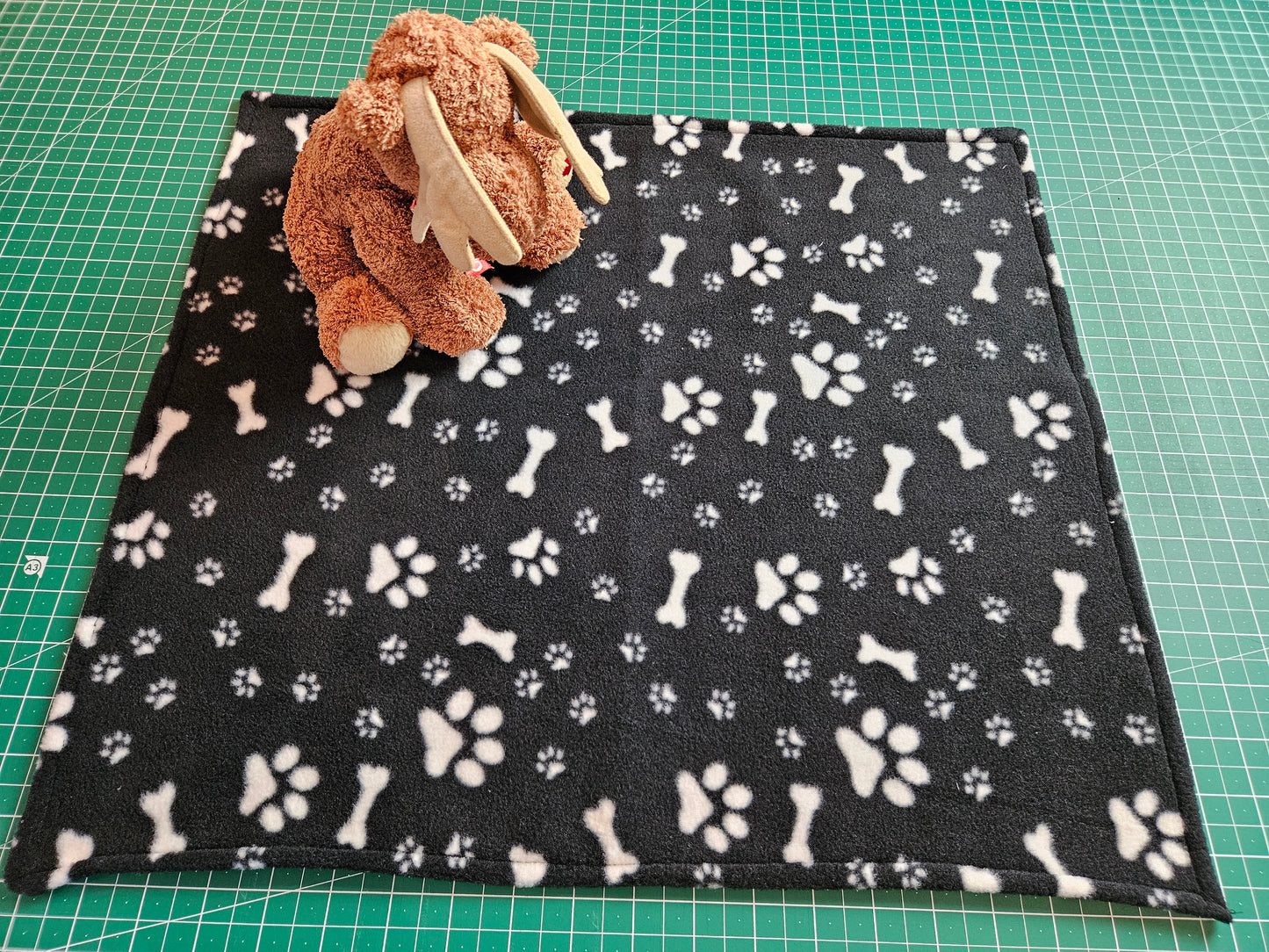 Little Pet Blanket. Dog theme Anti Pill Polar Fleece Fabric with paw and bones prints. Selection of pink or black background