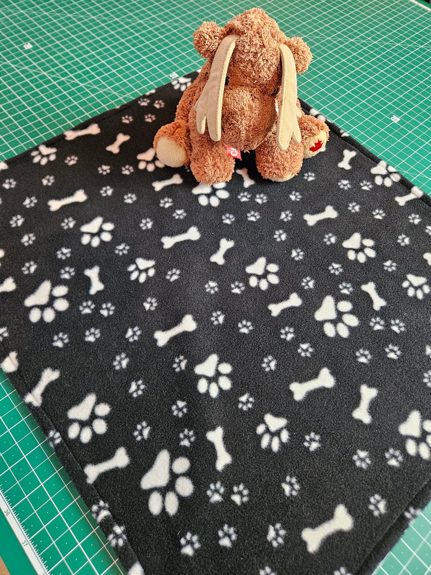 Little Pet Blanket. Dog theme Anti Pill Polar Fleece Fabric with paw and bones prints. Selection of pink or black background