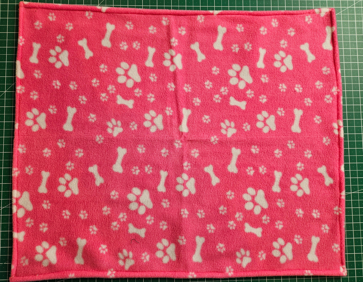 Little Pet Blanket. Dog theme Anti Pill Polar Fleece Fabric with paw and bones prints. Selection of pink or black background