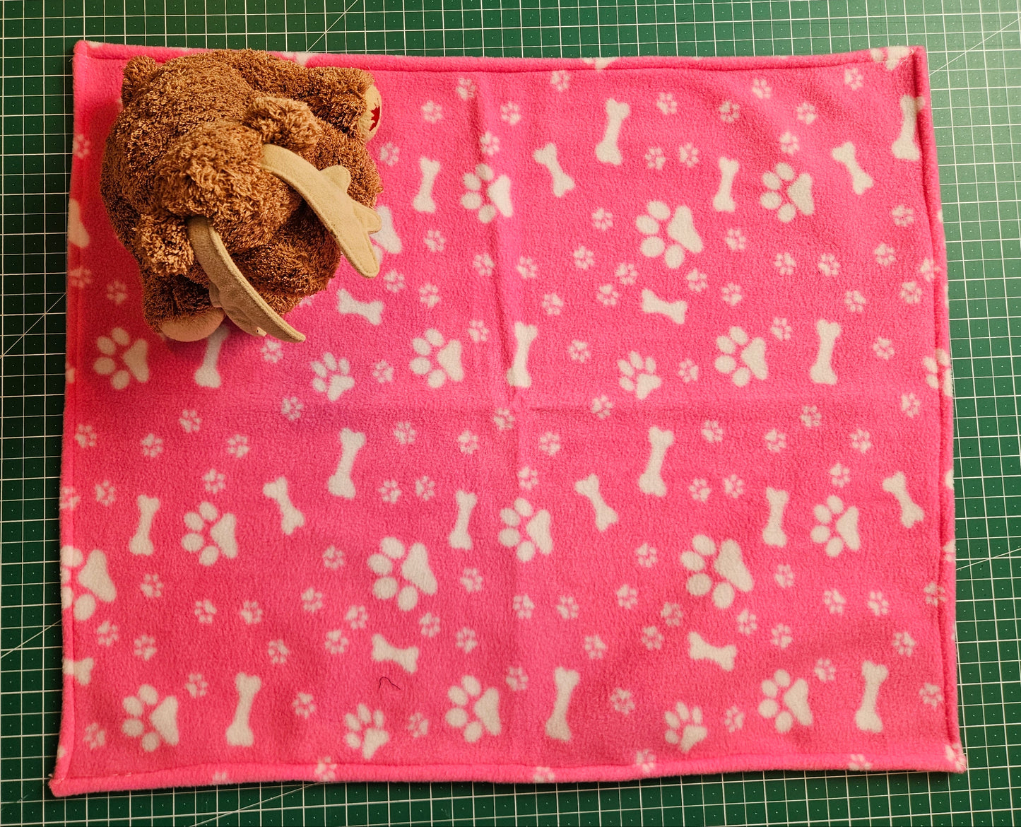 Little Pet Blanket. Dog theme Anti Pill Polar Fleece Fabric with paw and bones prints. Selection of pink or black background