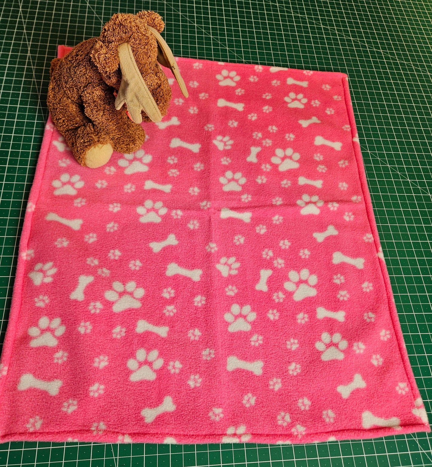 Little Pet Blanket. Dog theme Anti Pill Polar Fleece Fabric with paw and bones prints. Selection of pink or black background