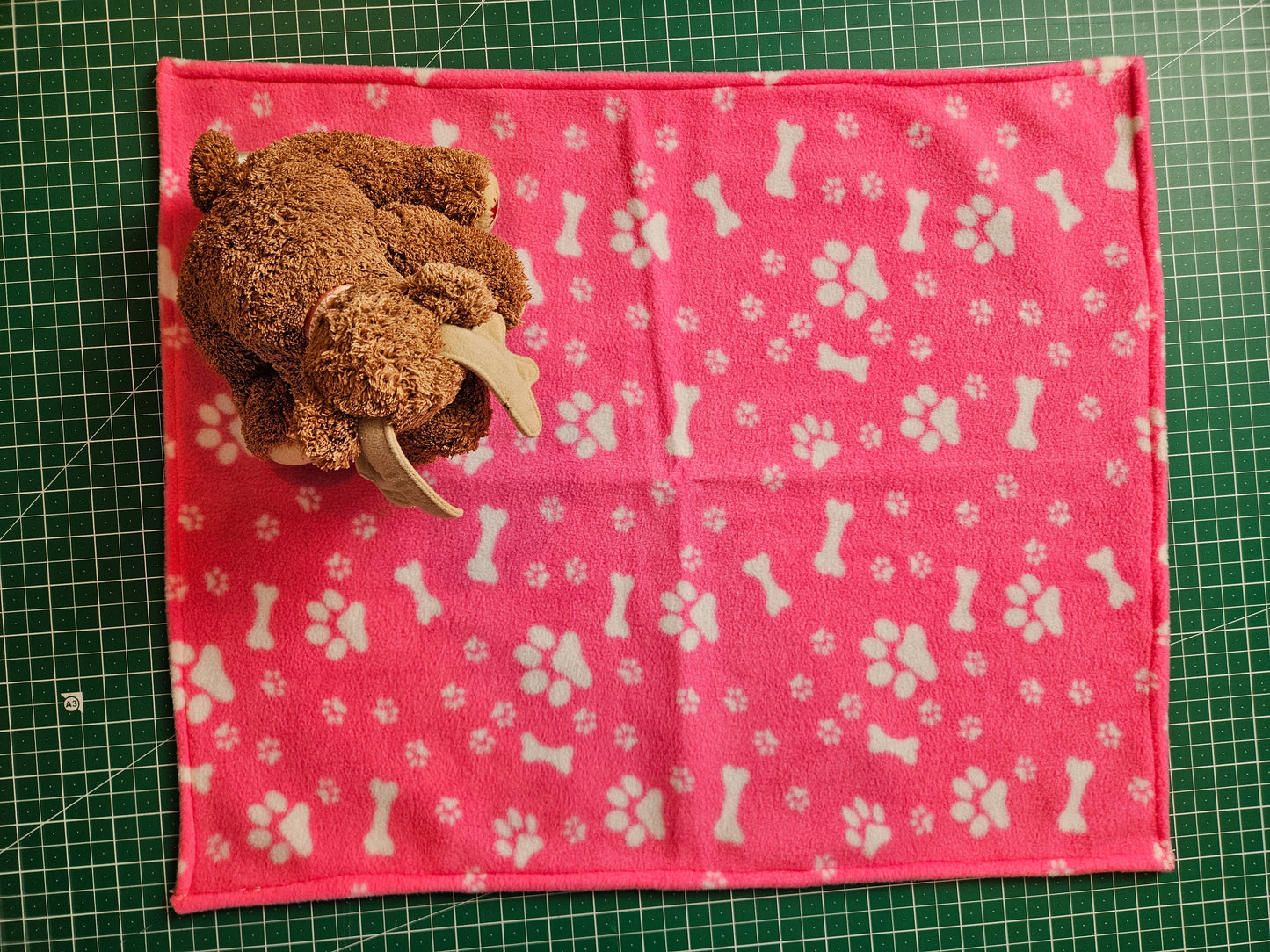 Little Pet Blanket. Dog theme Anti Pill Polar Fleece Fabric with paw and bones prints. Selection of pink or black background