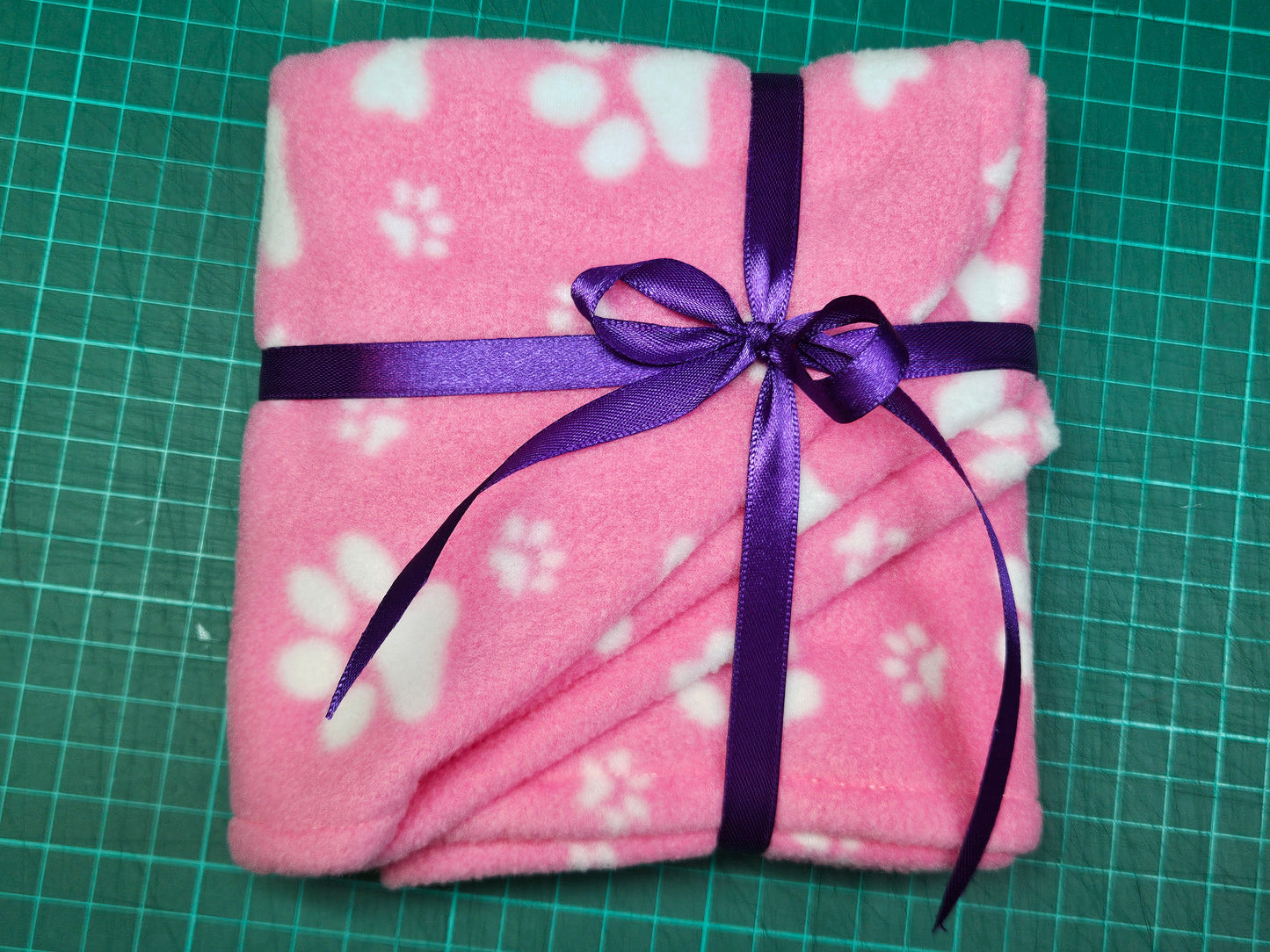 Little Pet Blanket. Dog theme Anti Pill Polar Fleece Fabric with paw and bones prints. Selection of pink or black background