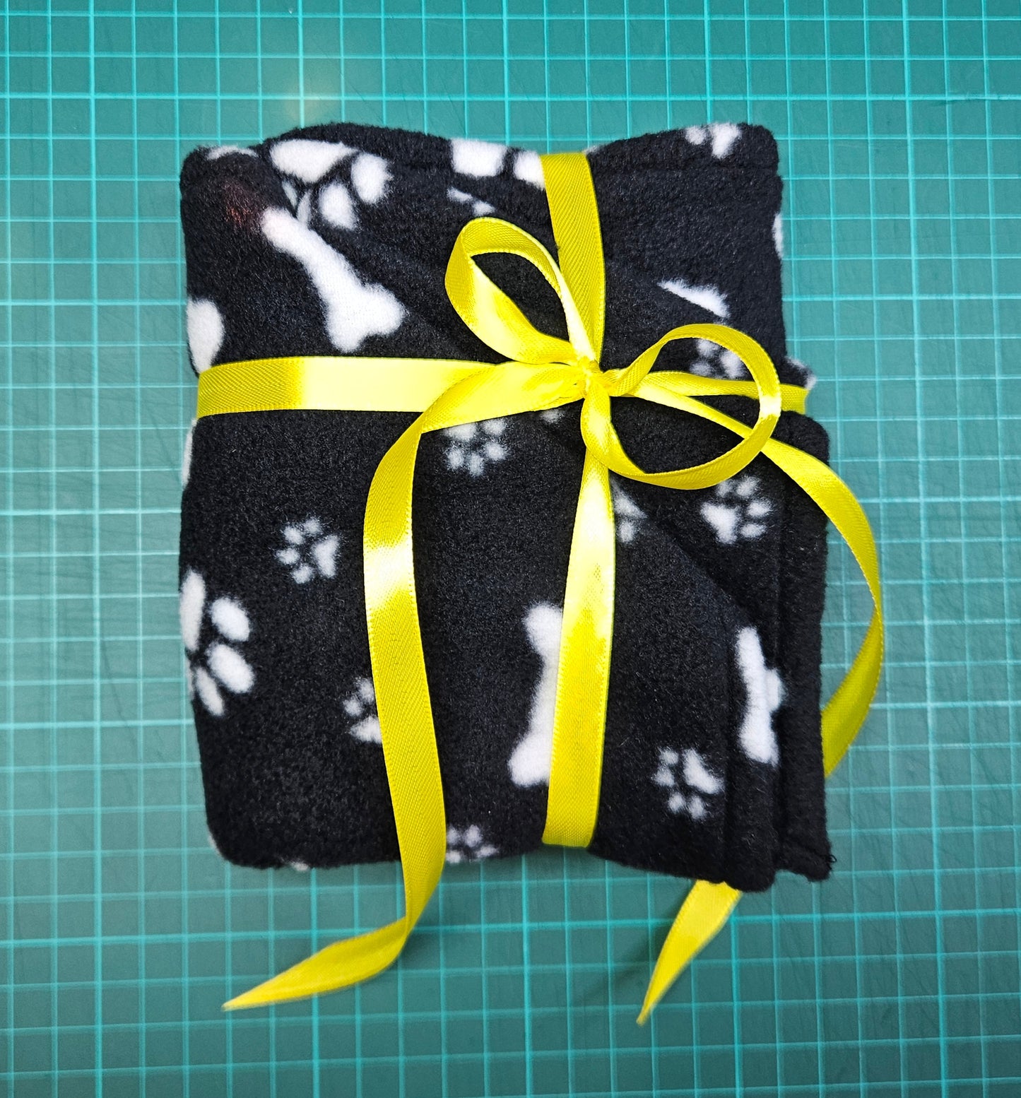 Little Pet Blanket. Dog theme Anti Pill Polar Fleece Fabric with paw and bones prints. Selection of pink or black background