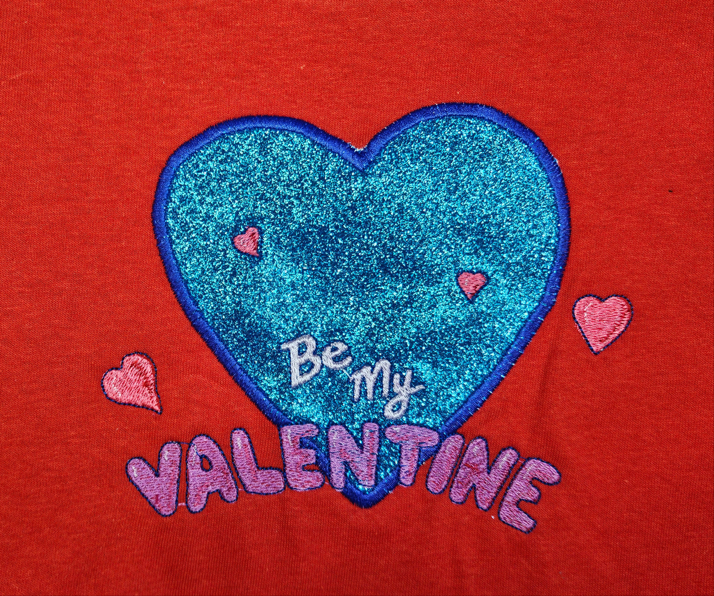 Be My Valentine design embroidered on Red T-Shirt. Comfortable, soft Tees for Toddlers, Youth and Adults.