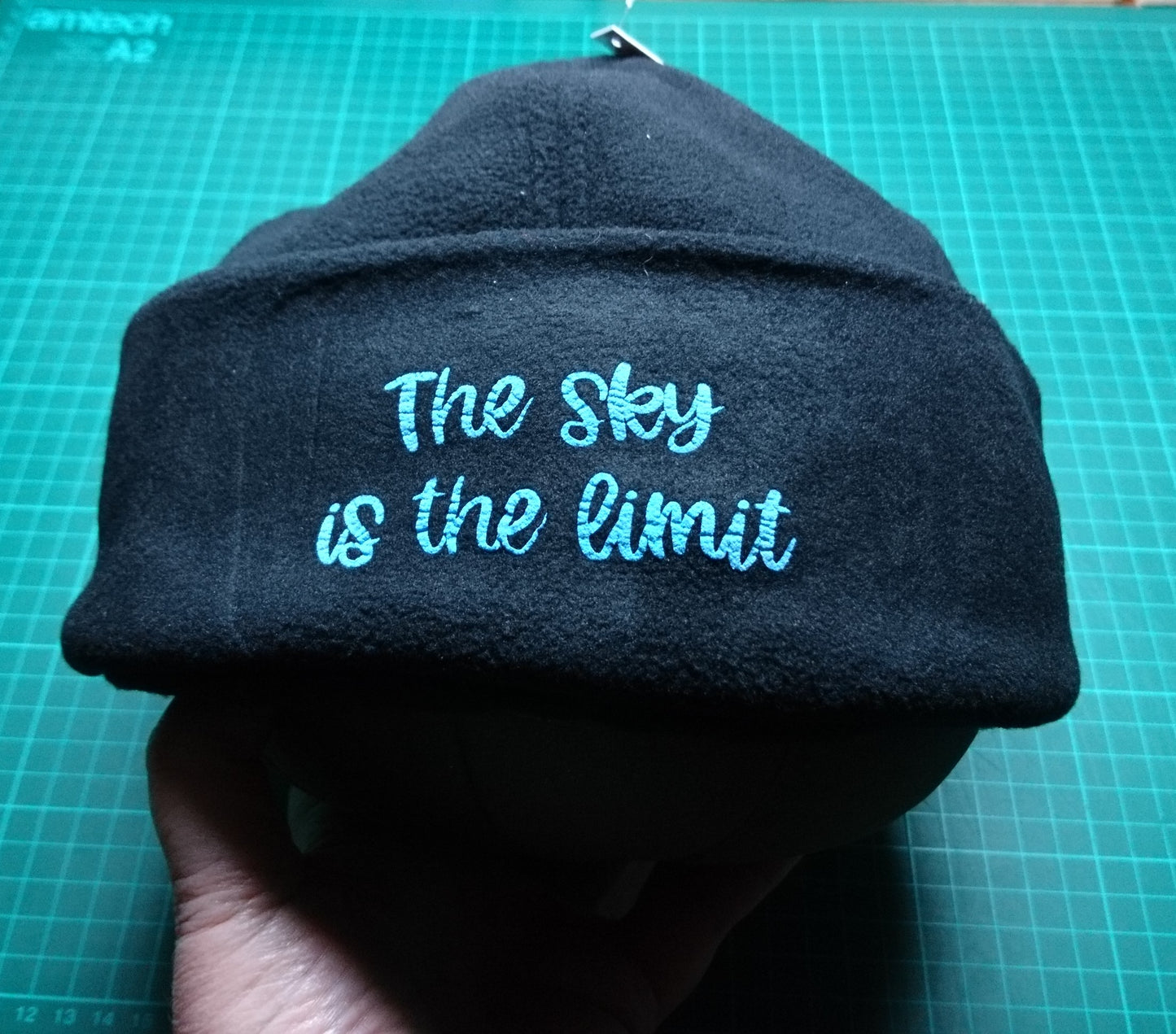 3D- Puff Glow in The Dark. Green Neon Vinyl on Black Supra Fleece Ski Hat with the quote "The Sky is the Limit". Comfy, Warm, Sport. One Size.