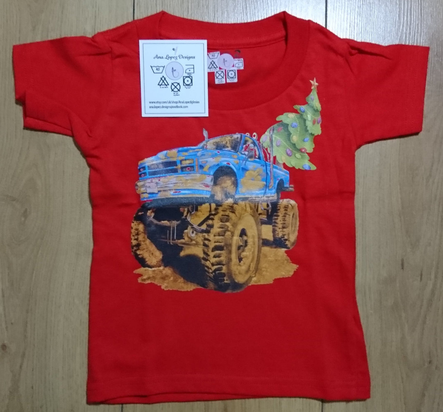 T-Shirts with the print of The Muddy Monster Truck carrying a Christmas Tree. Comfortable, soft Tees for Toddlers, Youth and Adults.