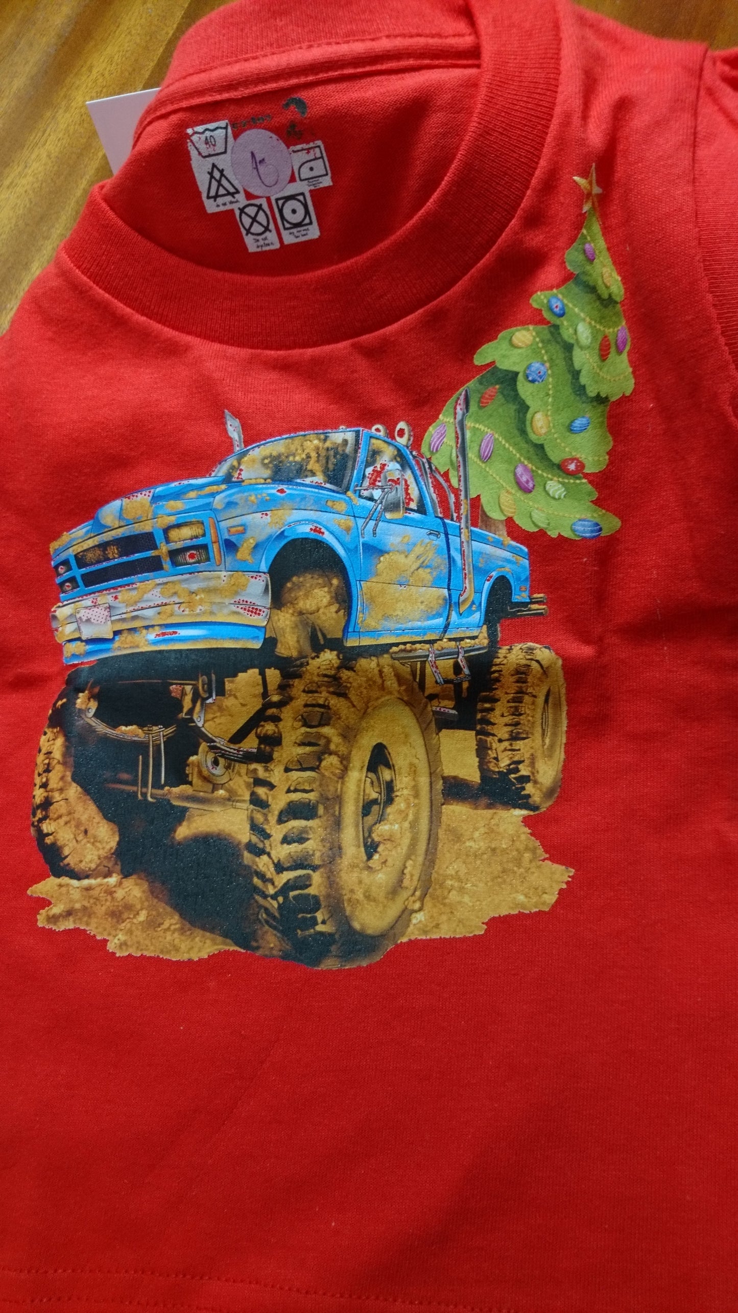 T-Shirts with the print of The Muddy Monster Truck carrying a Christmas Tree. Comfortable, soft Tees for Toddlers, Youth and Adults.