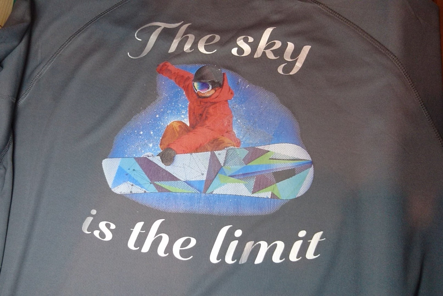 Ski Boarding Graphic with the quote "The Sky is the Limit" on a grey short sleeve T-Shirt. High quality sport Aircool Tees. The logo at the front can be personalised.