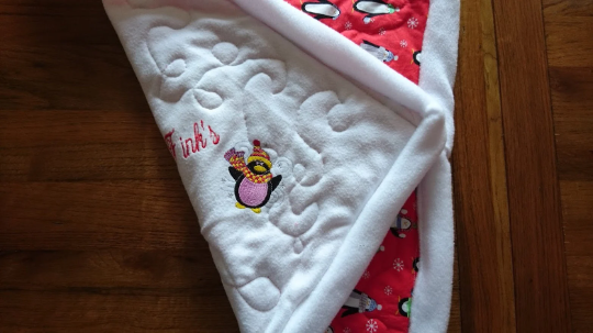 Personalised Pet Christmas Penguin Blanket. Handmade, Quilted and Double sided, with wadding in for more comfort. Penguin and pet's name embroidered.